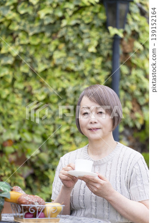 Senior woman drinking coffee on the terrace Senior woman drinking coffee on the terrace 139152164