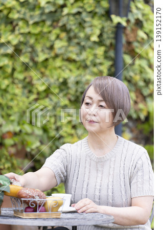 Senior woman drinking coffee on the terrace 139152170