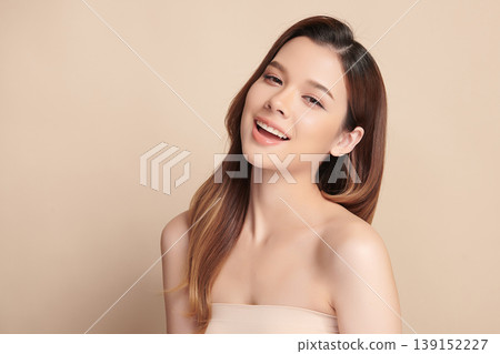 A beautiful young Asian woman with clean, fresh skin against a beige background. Skincare, facial treatment, cosmetology, beauty, and spa. An elegant portrait of an Asian woman. A beautiful young Asian woman with clean, fresh skin against a beige background. Skincare, facial treatment, cosmetology, beauty, and spa. An elegant portrait of an Asian woman. 139152227
