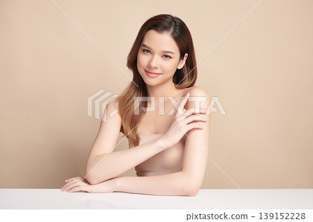 A beautiful young Asian woman with clean, fresh skin against a beige background. Skincare, facial treatment, cosmetology, beauty, and spa. An elegant portrait of an Asian woman. A beautiful young Asian woman with clean, fresh skin against a beige background. Skincare, facial treatment, cosmetology, beauty, and spa. An elegant portrait of an Asian woman. 139152228