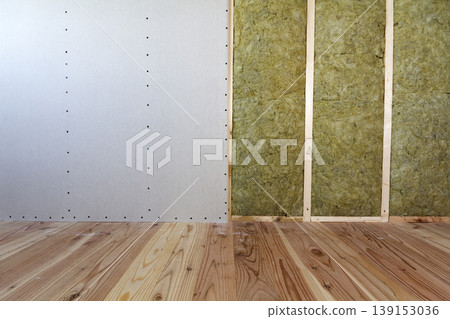 Wooden frame for future walls with drywall plates insulated with rock wool and fiberglass insulation staff for cold barrier. Comfortable warm home, economy, construction and renovation concept. Wooden frame for future walls with drywall plates insulated with rock wool and fiberglass insulation staff for cold barrier. Comfortable warm home, economy, construction and renovation concept. 139153036