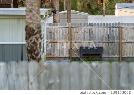 Wooden fence surrounding private property grounds for backyard protection and privacy in southern Florida Wooden fence surrounding private property grounds for backyard protection and privacy in southern Florida 139153038