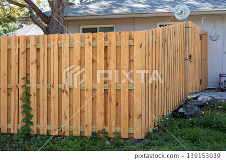Wooden fence for back yard protection and privacy. Timber plank fencing in Florida Wooden fence for back yard protection and privacy. Timber plank fencing in Florida 139153039