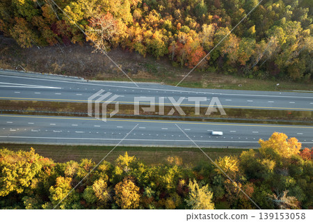 Wide multilane highway road in USA Appalachian mountains with fast driving cars. Above view of American transportation infrastructure Wide multilane highway road in USA Appalachian mountains with fast driving cars. Above view of American transportation infrastructure 139153058