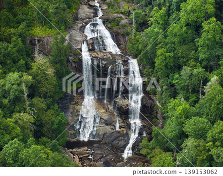 Whitewater Falls with falling down clear water from rocky boulders between green lush woods in Nantahala National Forest, North Carolina, USA Whitewater Falls with falling down clear water from rocky boulders between green lush woods in Nantahala National Forest, North Carolina, USA 139153062