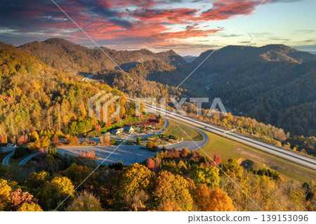 View from above of big parking rest area for cars and trucks near busy American highway with fast moving traffic. Recreational place in Appalachian mountains for interstate travel View from above of big parking rest area for cars and trucks near busy American highway with fast moving traffic. Recreational place in Appalachian mountains for interstate travel 139153096