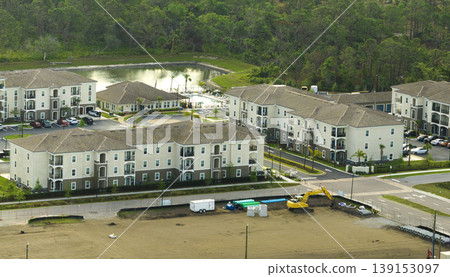 View from above of apartment residential condos in Florida suburban area. American condominiums as example of real estate development in USA suburbs View from above of apartment residential condos in Florida suburban area. American condominiums as example of real estate development in USA suburbs 139153097