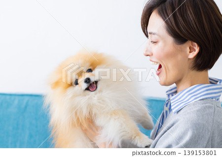 Lifestyle: A woman holding her pet dog Lifestyle: A woman holding her pet dog 139153801