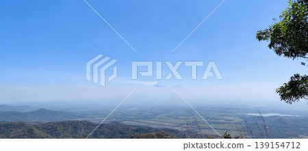 view of the land from the top of the hill with a cloudy blue sky view of the land from the top of the hill with a cloudy blue sky 139154712