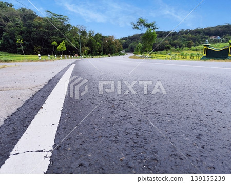 The highway is straight and far away without vehicles, the atmosphere in the hills is beautiful 139155239