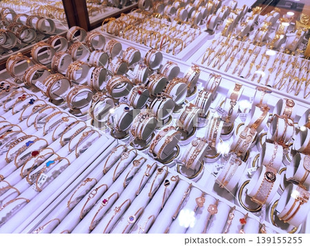 Photo of gold jewelry, necklaces, rings, bracelets in a glass display case Photo of gold jewelry, necklaces, rings, bracelets in a glass display case 139155255