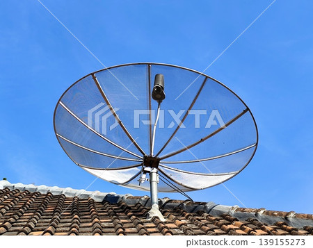 photo of a television signal satellite dish on the roof of a house photo of a television signal satellite dish on the roof of a house 139155273