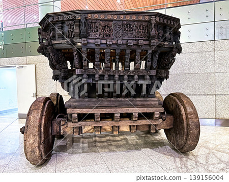 Ancient Wooden Temple Chariot with Intricate Carvings on Display Indoors Ancient Wooden Temple Chariot with Intricate Carvings on Display Indoors 139156004