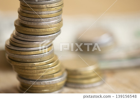 Stacked coins on wooden surface representing financial growth and savings Stacked coins on wooden surface representing financial growth and savings 139156548