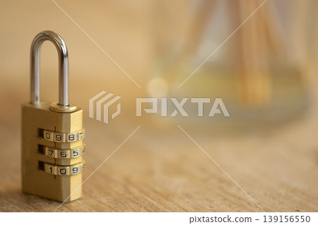 Brass combination padlock on wooden desk with copy space Brass combination padlock on wooden desk with copy space 139156550