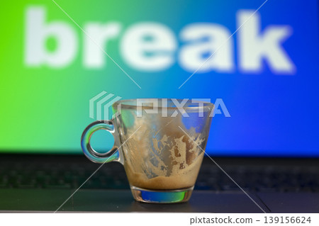 Empty espresso cup on laptop with break message on screen 139156624