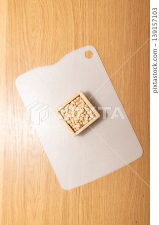 Soybeans in a measuring box placed on a cutting board Soybeans in a measuring box placed on a cutting board 139157103