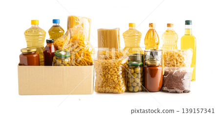 Foodstuffs in donation box isolated on white background. Foodstuffs in donation box isolated on white background. 139157341