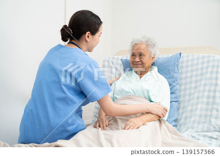 Asian doctor checking and treat elderly woman patient health in hospital. Asian doctor checking and treat elderly woman patient health in hospital. 139157366