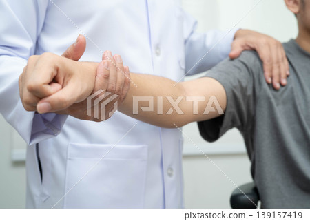Physical therapy, Asian therapist doctor treat perform pain young man in hospital. Physical therapy, Asian therapist doctor treat perform pain young man in hospital. 139157419