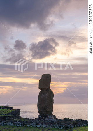 Serene moai statue standing on easter island chile overlooking calm ocean Serene moai statue standing on easter island chile overlooking calm ocean 139157898