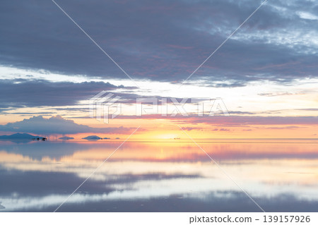 Serene sunset reflection on uyuni salt flat bolivia vast landscape Serene sunset reflection on uyuni salt flat bolivia vast landscape 139157926