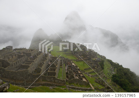 Mysterious fog blankets ancient stone ruin of machu picchu in green mountain Mysterious fog blankets ancient stone ruin of machu picchu in green mountain 139157965