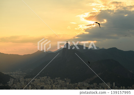 Peaceful golden sunset over mountain landscape and cityscape of rio de janeiro with corcovado mountain silhouette Peaceful golden sunset over mountain landscape and cityscape of rio de janeiro with corcovado mountain silhouette 139157995