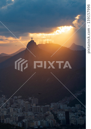 Hopeful sunbeam at sunset over Corcovado mountain in Rio de Janeiro Brazil. dramatic sky above famous landmark Hopeful sunbeam at sunset over Corcovado mountain in Rio de Janeiro Brazil. dramatic sky above famous landmark 139157996