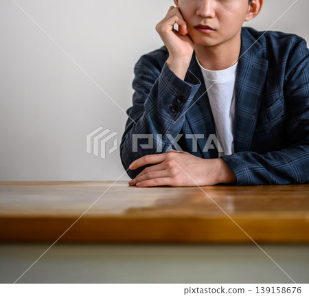 A man deep in thought at the table A man deep in thought at the table 139158676