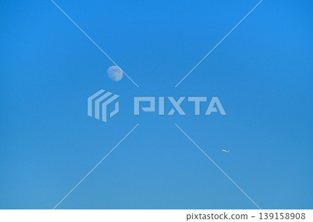 Moon and plane in the blue sky Moon and plane in the blue sky 139158908