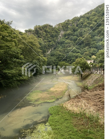 Scenic forest landscape with a river and lush greenery, ideal for nature and travel backgrounds 139158945