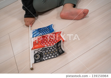 A small carp streamer flag and a child's hand A small carp streamer flag and a child's hand 139158964