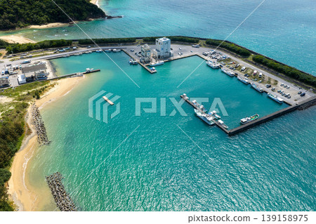 An aerial photograph of the fishing port and emerald green sea of Oura Bay in Okinawa Prefecture. An aerial photograph of the fishing port and emerald green sea of Oura Bay in Okinawa Prefecture. 139158975