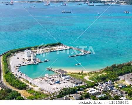 An aerial photograph of the fishing port and emerald green sea of Oura Bay in Okinawa Prefecture. An aerial photograph of the fishing port and emerald green sea of Oura Bay in Okinawa Prefecture. 139158981