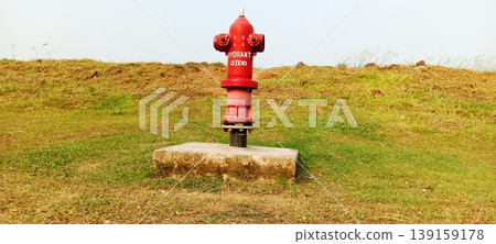 Fire extinguisher in open field Fire extinguisher in open field 139159178
