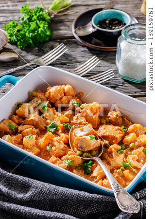Indian fish curry with cauliflower and green peas 139159761