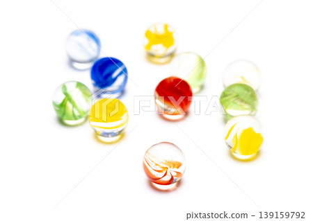 A close-up photograph of multiple marbles arranged in a row. A close-up photograph of multiple marbles arranged in a row. 139159792
