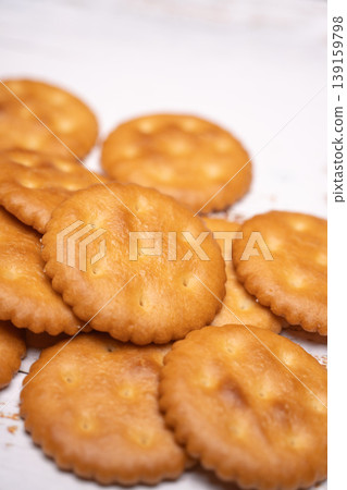 A still-life photograph capturing a collection of round crackers. A still-life photograph capturing a collection of round crackers. 139159798