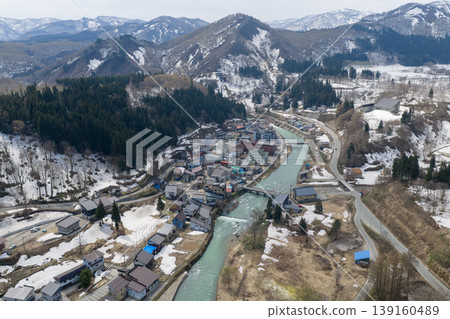 An aerial photograph taken in April of the hot spring town of Hijiori Onsen in Yamagata Prefecture, surrounded by snow-capped mountains. An aerial photograph taken in April of the hot spring town of Hijiori Onsen in Yamagata Prefecture, surrounded by snow-capped mountains. 139160489