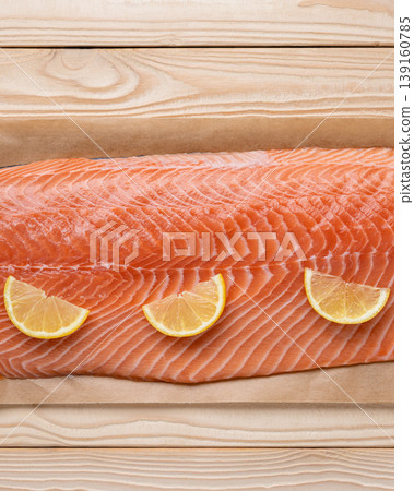 Fresh salmon fillet lemon slices vertical 139160785