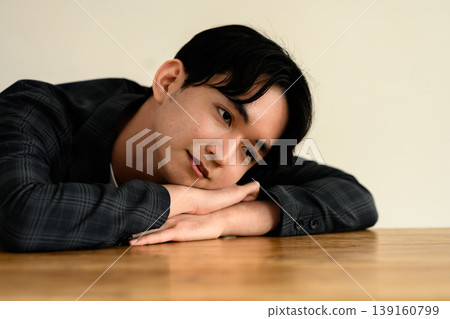 A man leaning against a table A man leaning against a table 139160799