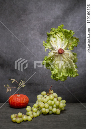 Still life with salad, pumpkin, and grapes 139160808