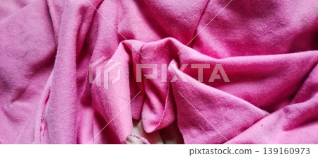 Pink fabric texture with natural folds and wrinkles Pink fabric texture with natural folds and wrinkles 139160973