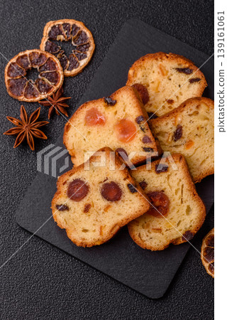 Fruit cake, a dessert with cherries, plums, and raisins for a festive Christmas table. Fruit cake Fruit cake, a dessert with cherries, plums, and raisins for a festive Christmas table. Fruit cake 139161061