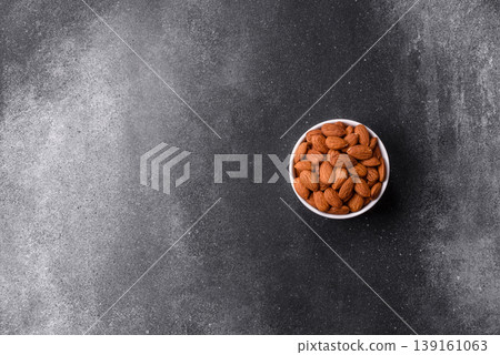Raw and peeled almonds as a healthy food ingredient. Almonds as a food background 139161063