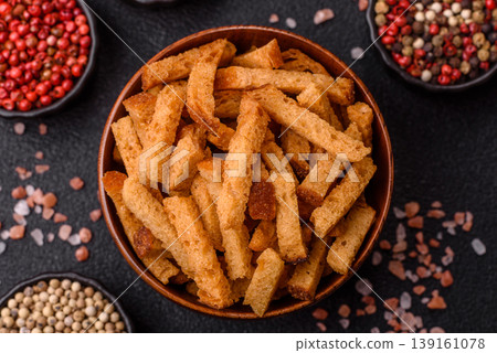 Croutons or crackers made from rye bread with garlic, salt, and spices. Croutons with salt Croutons or crackers made from rye bread with garlic, salt, and spices. Croutons with salt 139161078