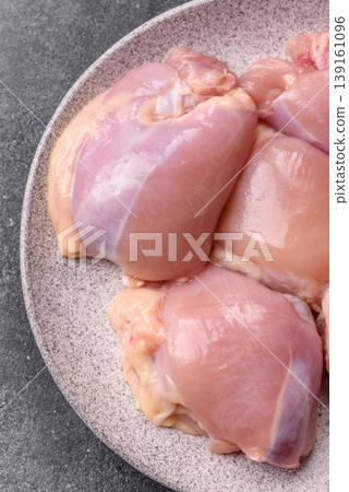Raw chicken thigh fillet, boneless and skinless, for roasting. Raw thigh fillet 139161096