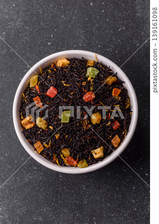 Dry black tea with herbal leaves and aromatic additives. Dry fruity black tea Dry black tea with herbal leaves and aromatic additives. Dry fruity black tea 139161098