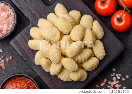 Raw homemade potato gnocchi, made with salt and spices, ready for lunch. Raw gnocchi Raw homemade potato gnocchi, made with salt and spices, ready for lunch. Raw gnocchi 139161103